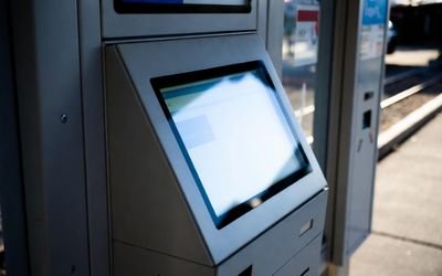 Outdoor self-service kiosk with high brightness LCD display visible under strong sunlight.