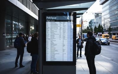 Outdoor bus stop digital signage using a high brightness LCD readable in sunlight.
