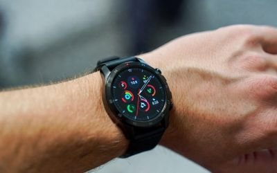 Smartwatch with a round LCD display worn during daily activities.