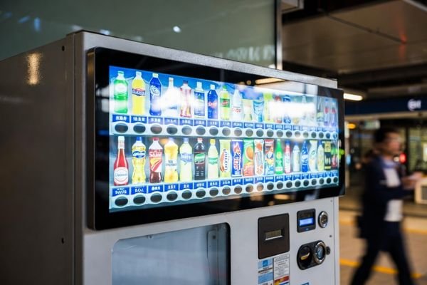 32 inch stretched display mounted on top of a vending machine showing digital advertisements, ultra-wide high brightness bar LCD for vending applications
