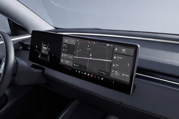 Ultra-wide bar type display embedded in a vehicle dashboard showing navigation and system information