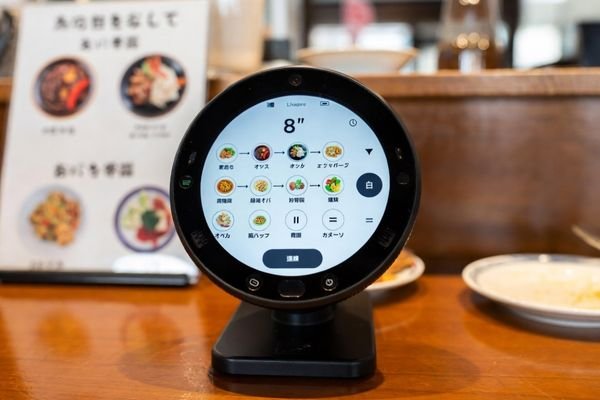 round lcd module on compact self ordering kiosk in small restaurant in japan