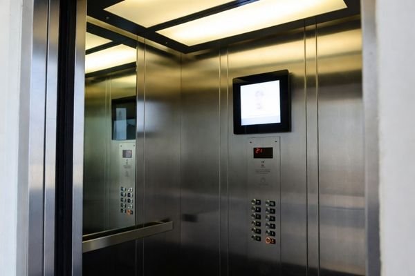 Square lcd display module used as an elevator information screen in an office building