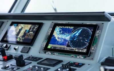 Ship bridge navigation console with integrated 10.1-inch+ LCD display module showing marine chart/radar graphics