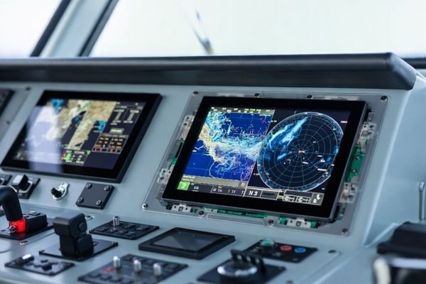 Ship bridge navigation console with integrated 10.1-inch+ LCD display module showing marine chart/radar graphics