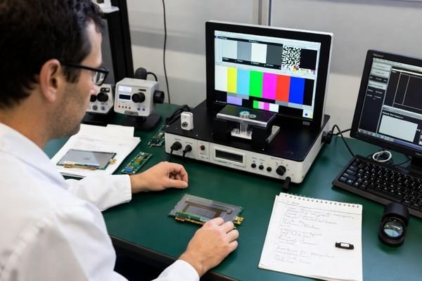 An engineer testing an LCD module with specific application content in a lab setting