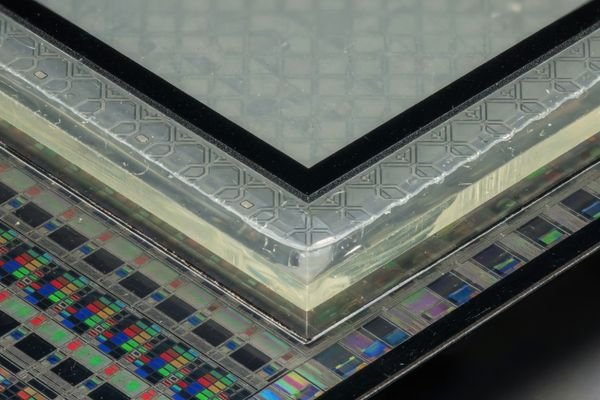 An image showing an LCD module front stack with LCD panel, touch sensor, cover glass, printed black border, bonding layer, and enclosure opening