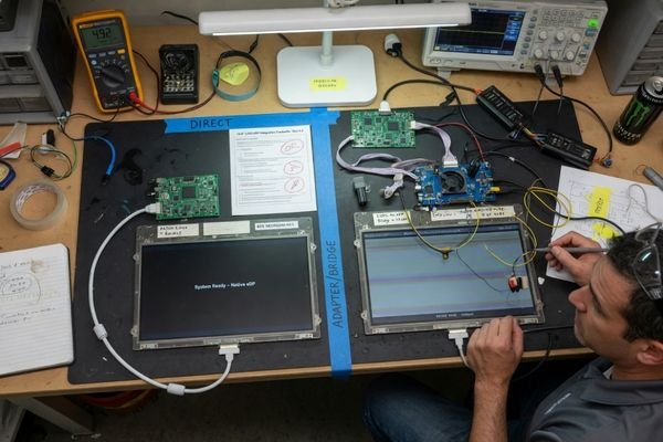 An image showing a clean direct connection from a processor to an LCD versus a connection that requires a separate bridge or adapter board