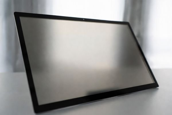 Industrial LCD module surface showing controlled light scattering and softened reflections caused by haze